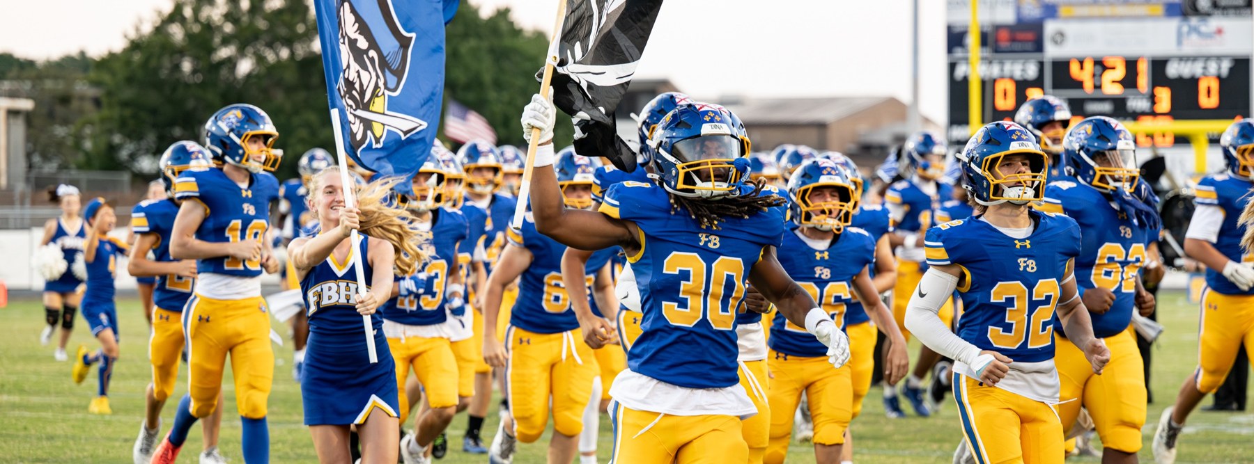 Fernandina Beach High School football players and cheerleaders on the field